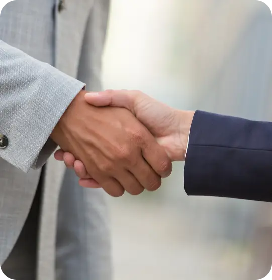 Two people shaking hands, symbolising trust, partnership, and supportive coaching relationship