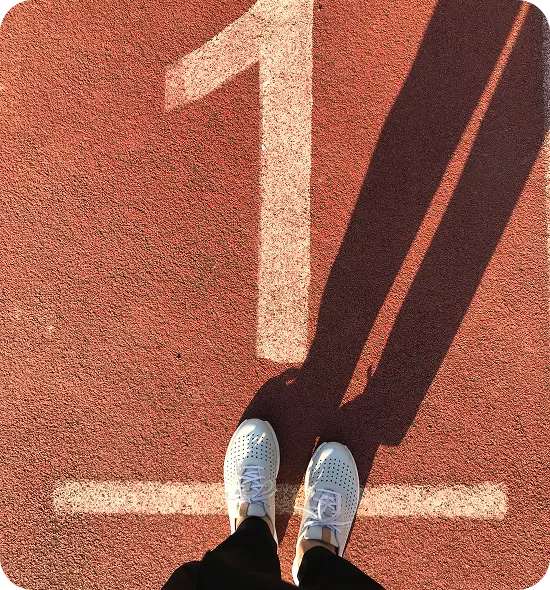 Person standing at the starting line marked number one, symbolising the first step towards change and better health